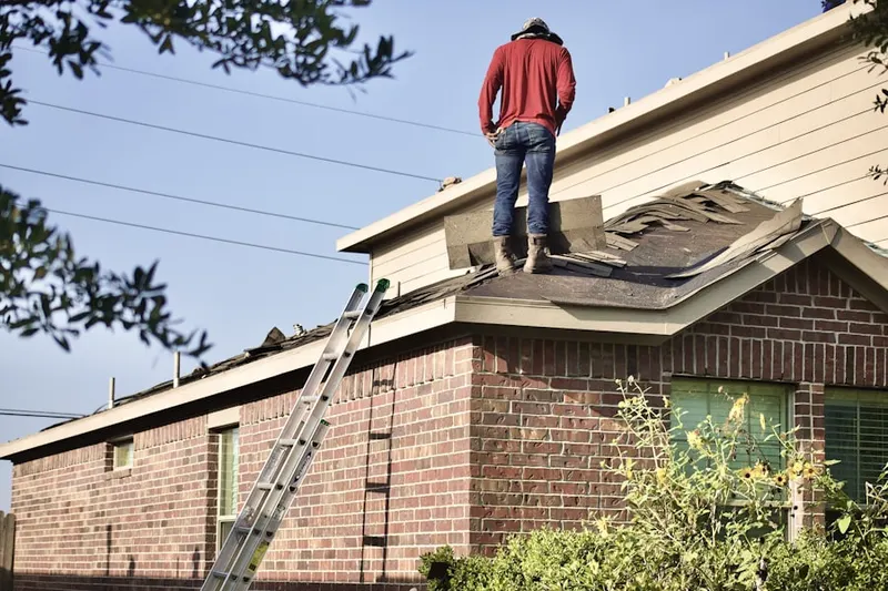 Professional roofer working on a residential roof in Lanes Corner
